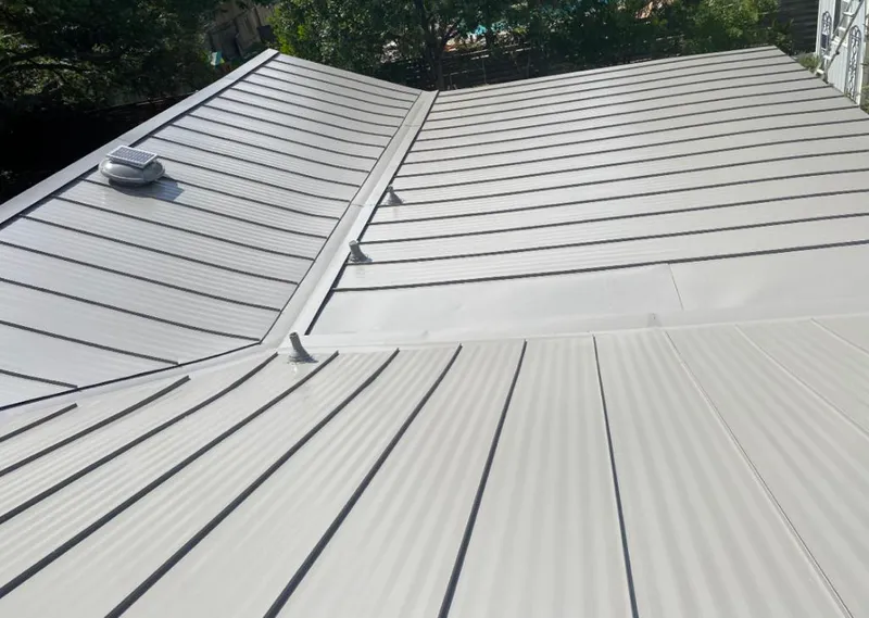 Solar attic fan installed on a metal roof for Roof Ventilation in Grants Pass